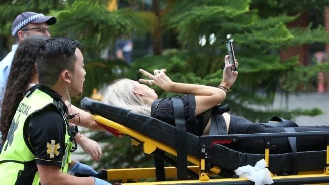 Festival attendee takes selfie as she is wheeled to ambulance - a masterpiece