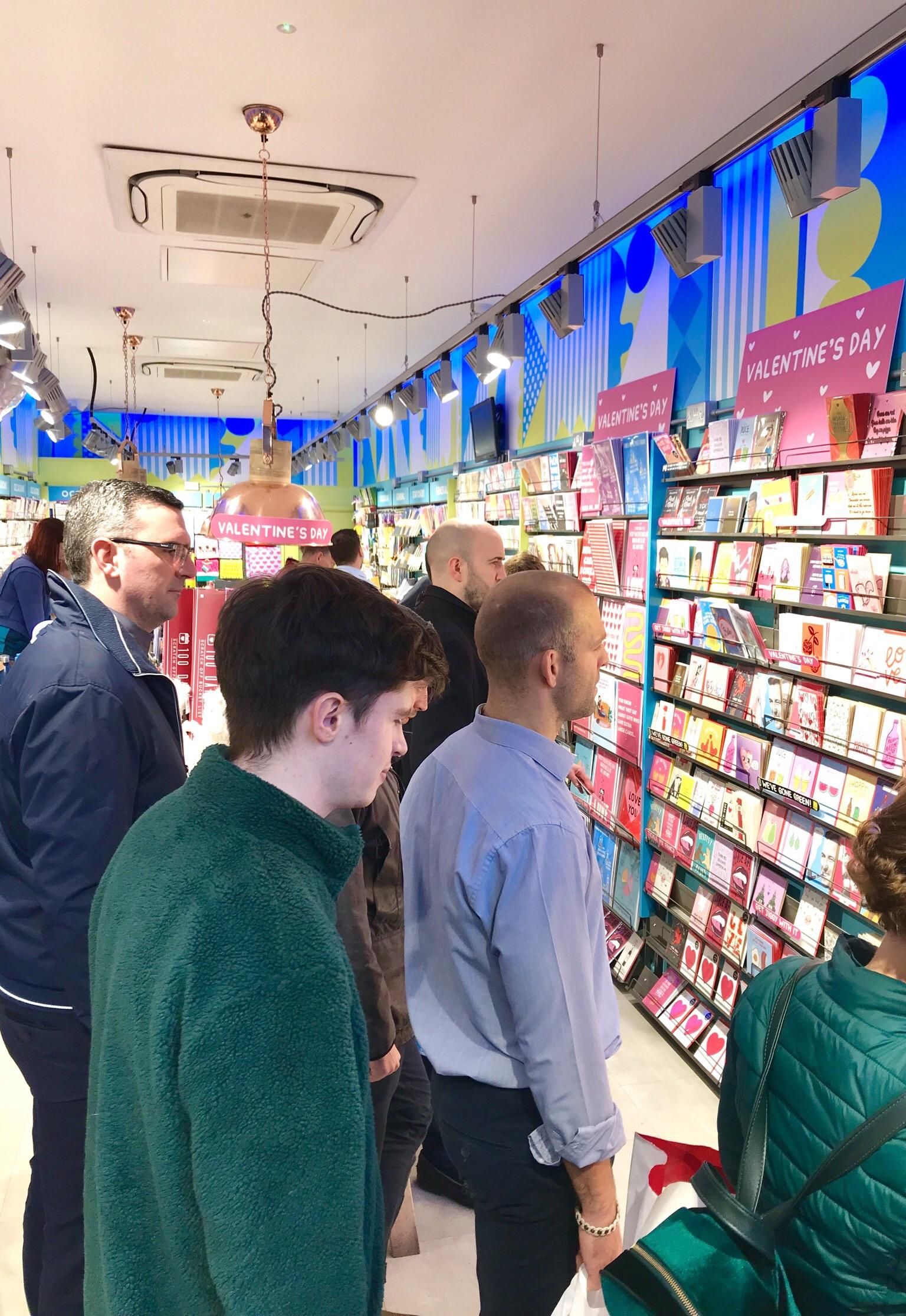 Men staring into the dark abyss of valentines day cards.
