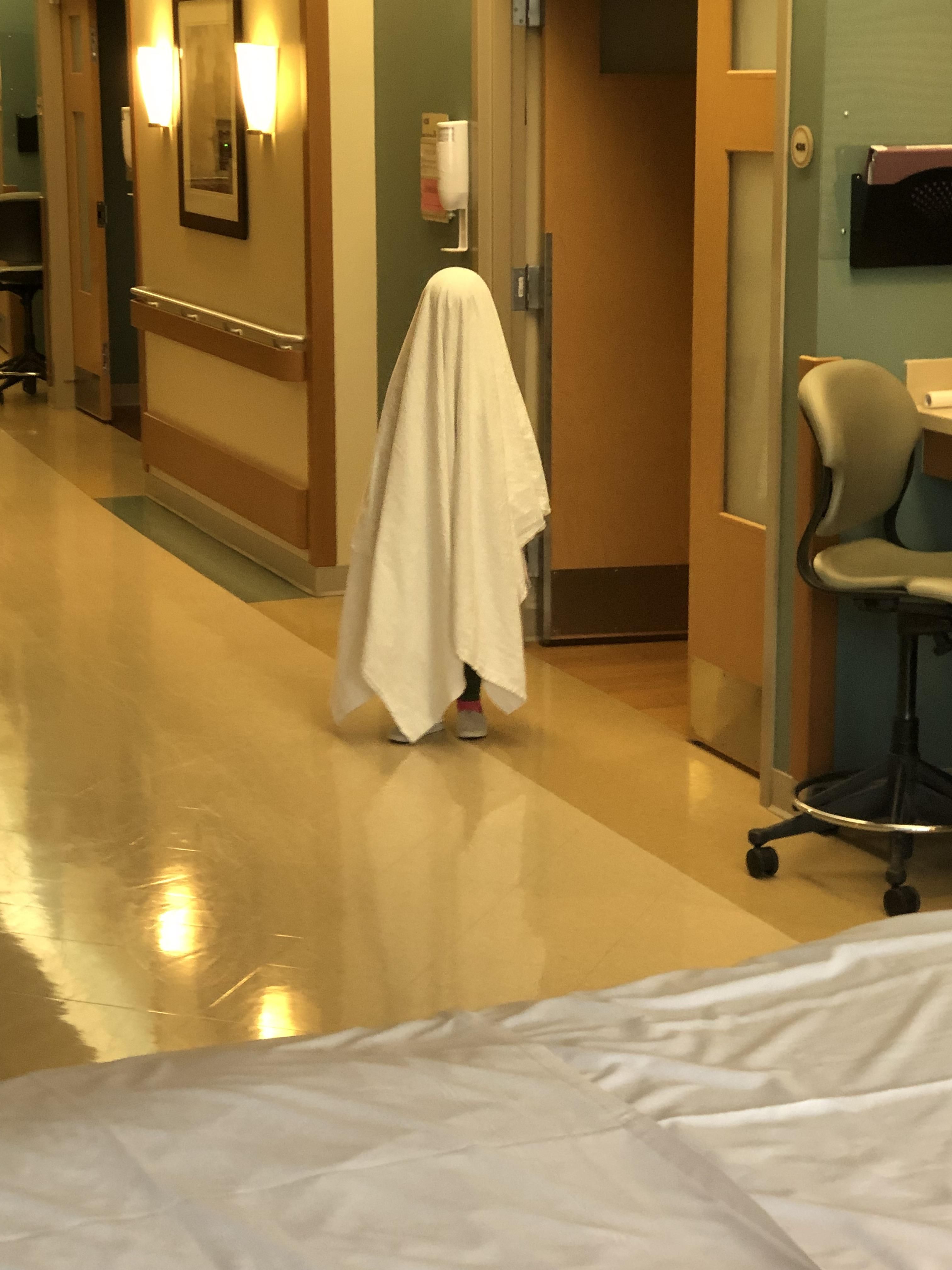 My daughter pretending to be a ghost at the hospital. Probably a poor choice.