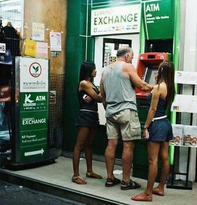 Kind-hearted man is withdrawing money from an ATM so that he can buy food for these starving young girls in Thailand.