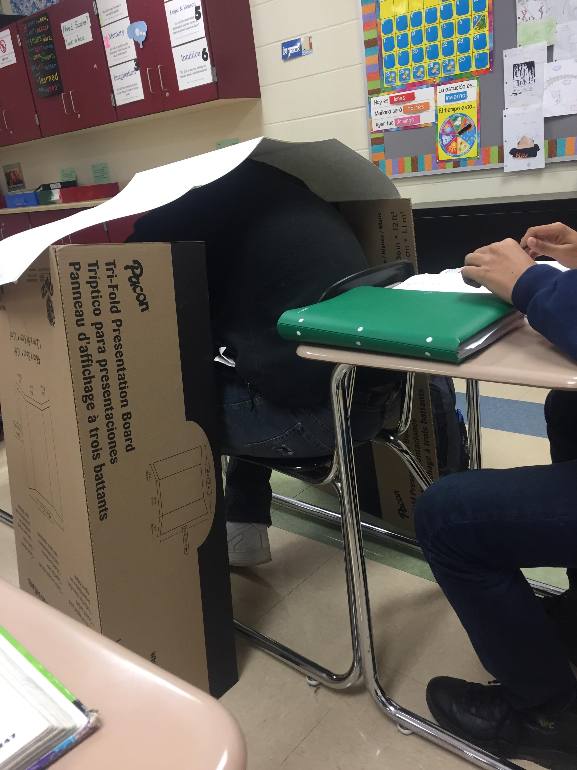 My teacher likes messing with people that fall asleep in class. Today he built a small shelter for a napping kid next to me.