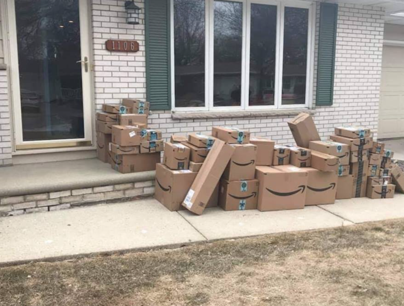 Man's wife saves all her Amazon purchase boxes from the past 2 years to place on her porch for her husband to come home and see this April 1.