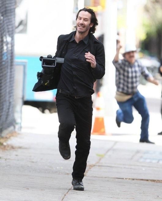 A photo of Keanu Reeves running away with a camera he took from a Paparazzi guy is currently my favorite photo on the internet.