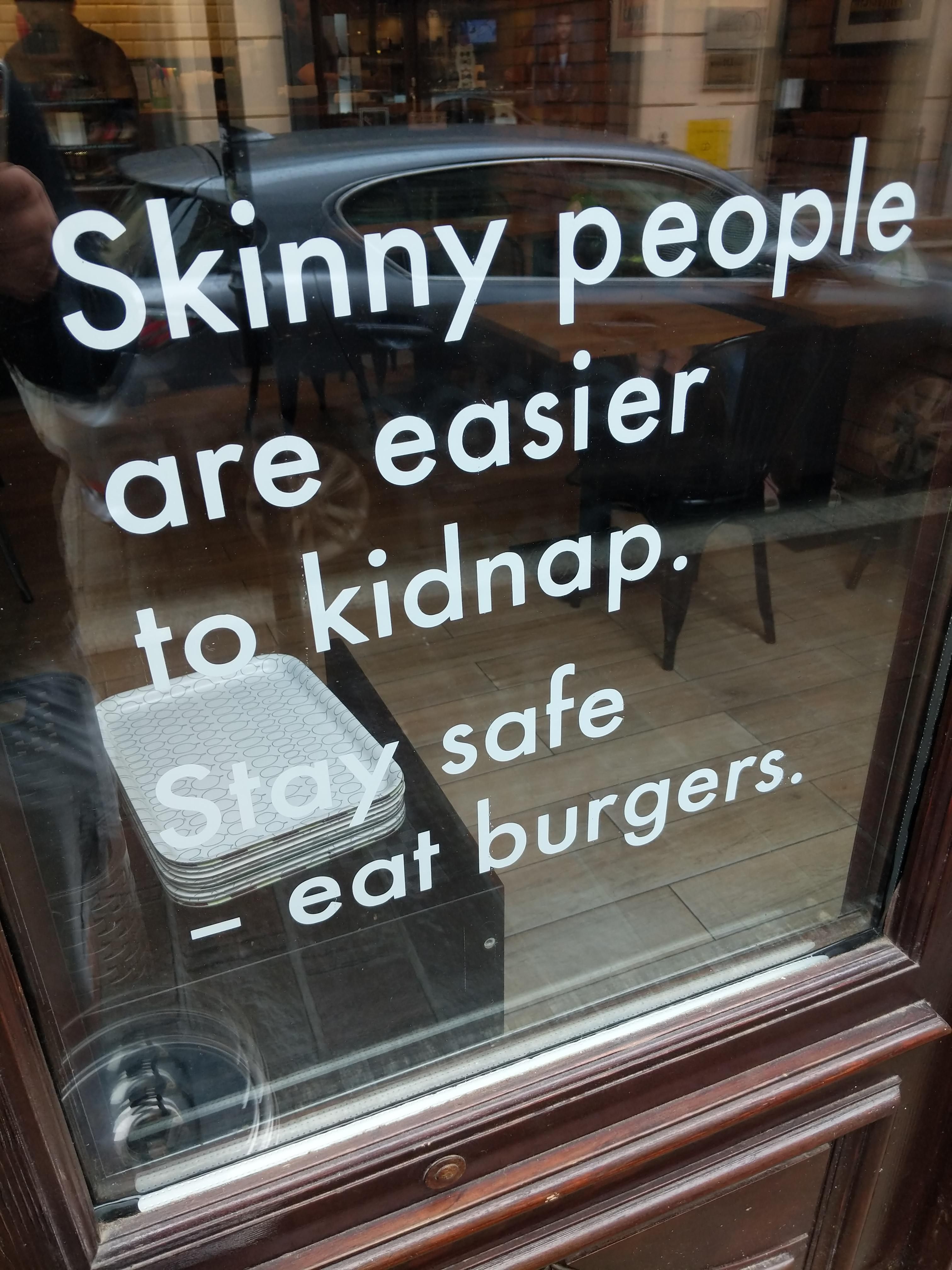 Sign on a window of a burger joint in Krakow, Poland