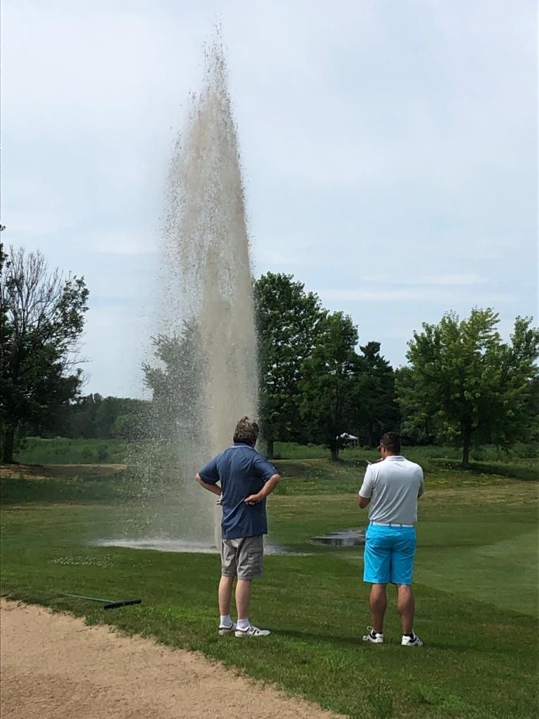My Dad hit a sprinkler dead on with one of his drives today at a local golf tournament. He's in the blue shirt