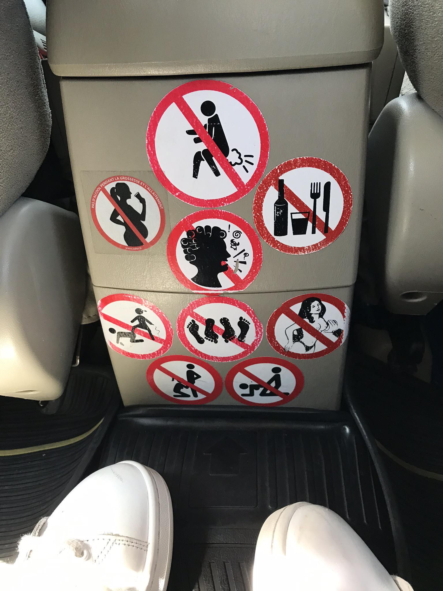 Stickers in the back of a taxi I took on my vacation in Thailand