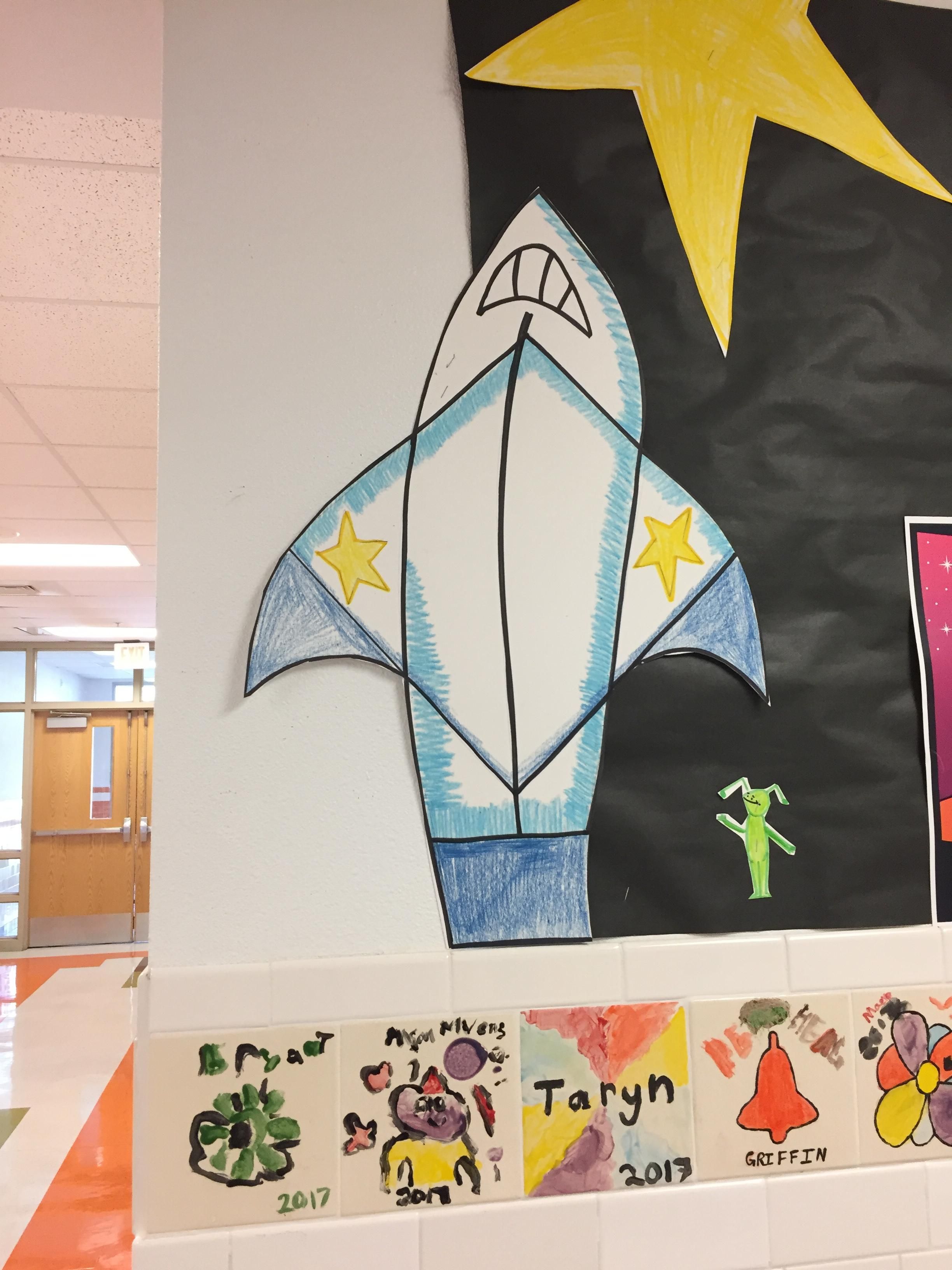 I was at my daughter's school today. I asked her why there was a shark ripping off its shirt....."mom, that's a rocket ship".