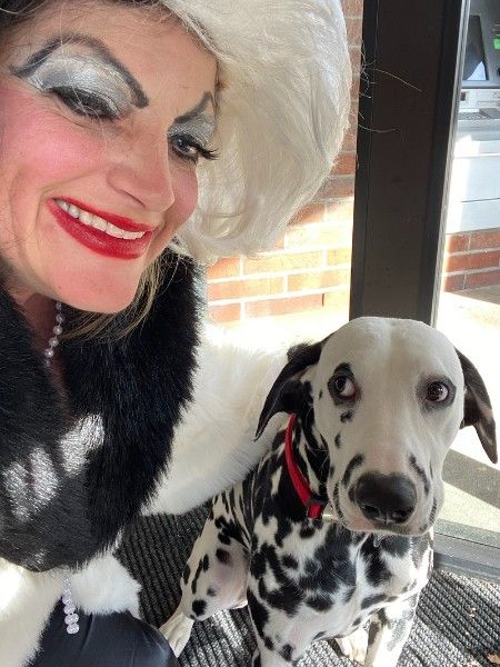 This Dalmatian is a bit concerned about the Cruella de Vil look-alike.