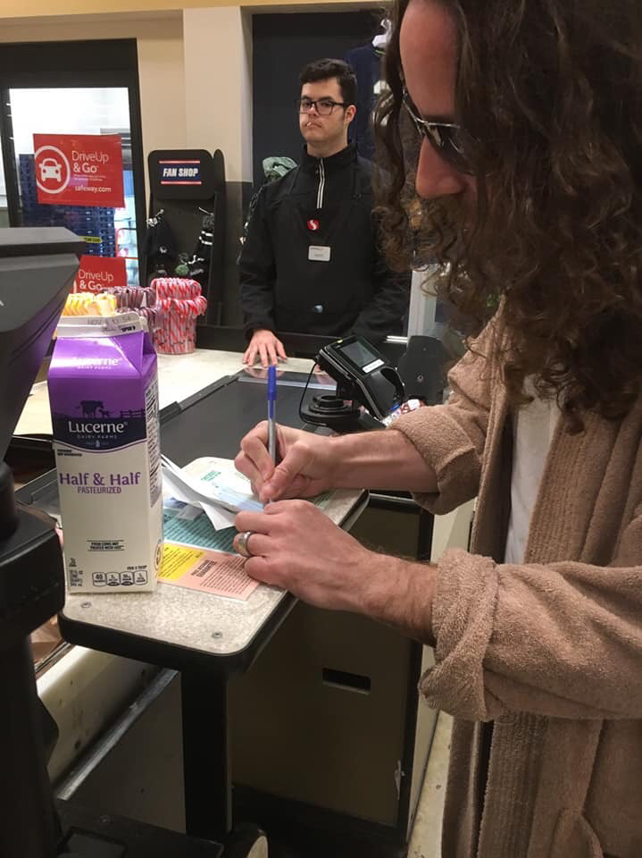 friend buying half & half with a check at the grocery store on Halloween