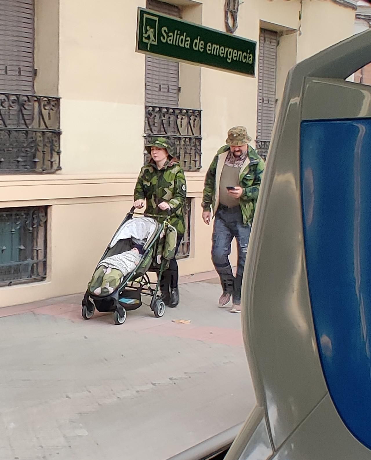 A stroller left alone in the middle of the city. No parents or baby to be seen