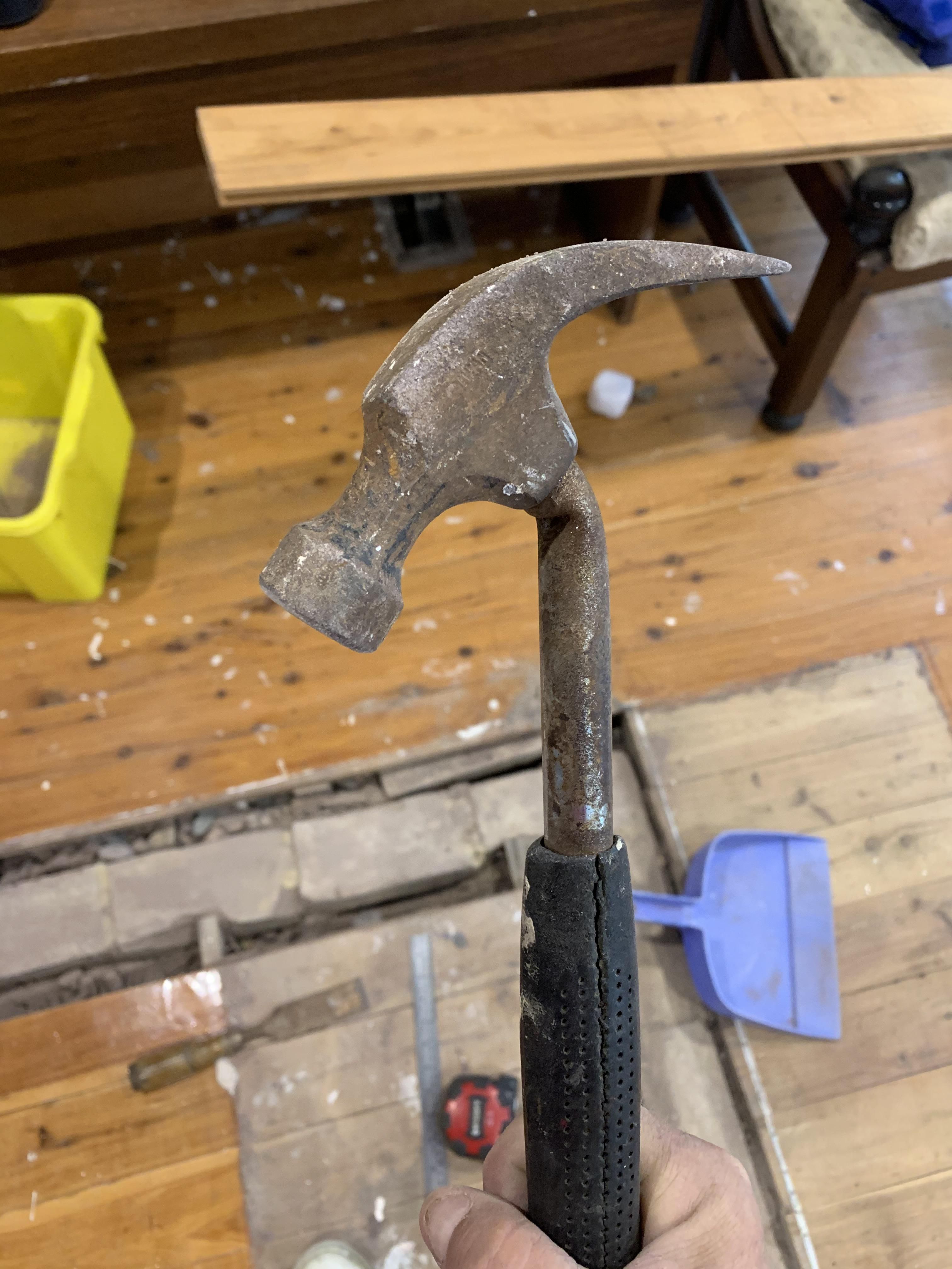 I broke a hammer trying to pry a nail out of the floorboards and it looks really disappointed in itself