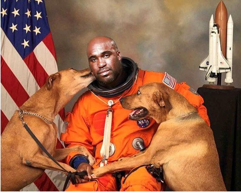 NASA Astronaut gets his official picture taken with his dogs.