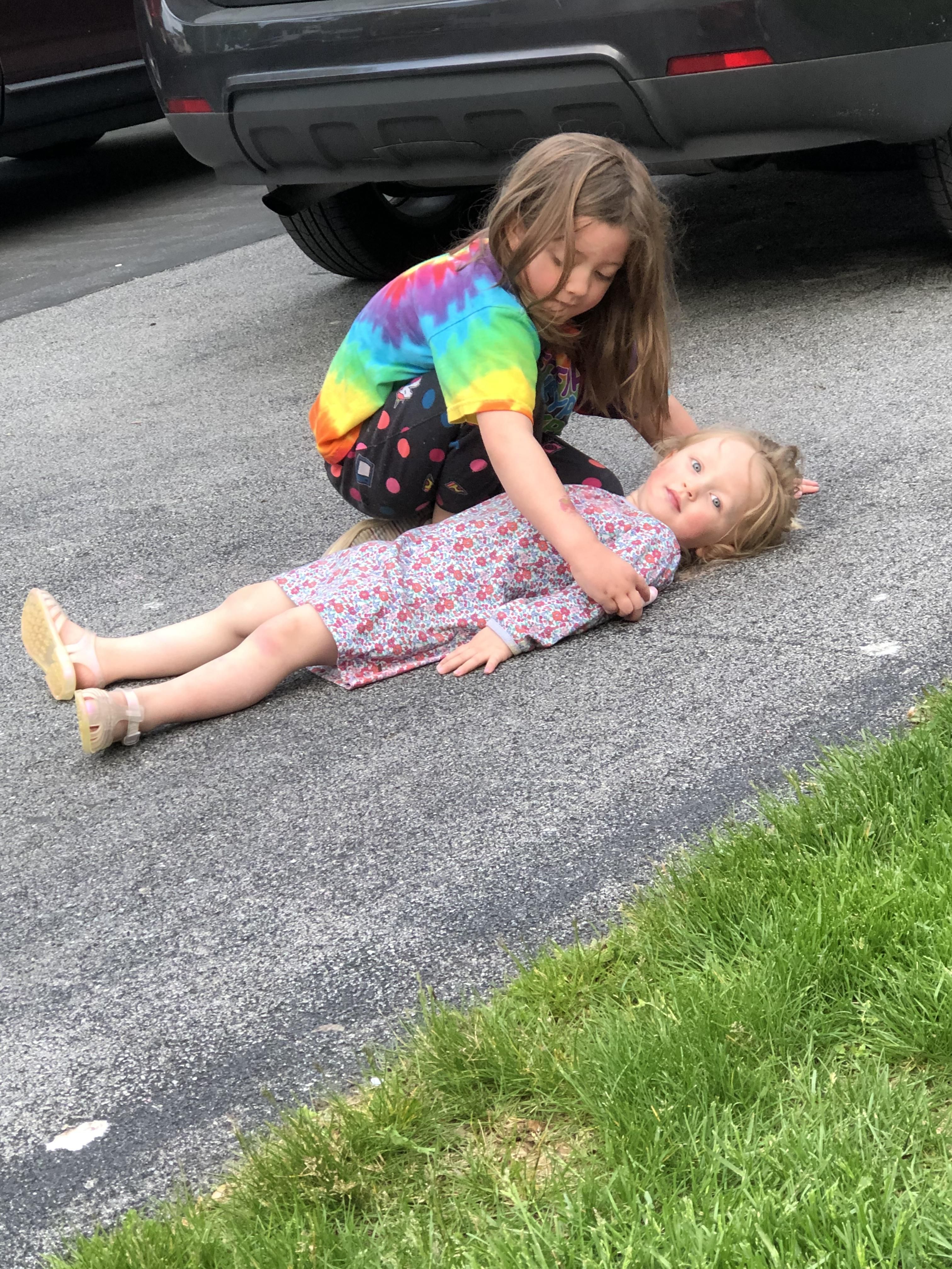 My daughters wanted to play with chalk outside. I came out to them setting up a fake crime scene.