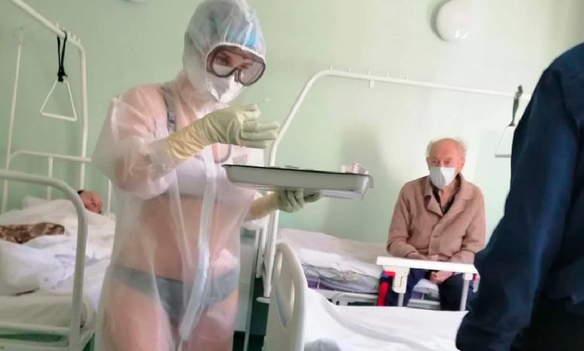 Nurse who only wore underwear under transparent PPE gown on male hospital ward in Russia because she was 'too hot' is disciplined