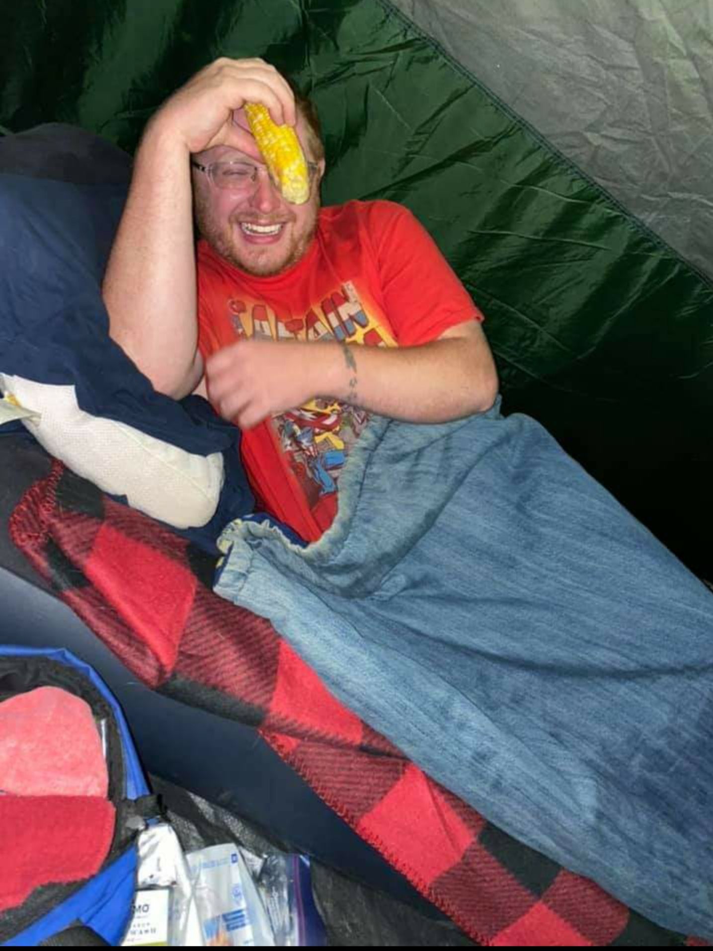 Heard a weird crunching in our tent while camping, look over to find my cousin enjoying an ear of corn very intoxicated