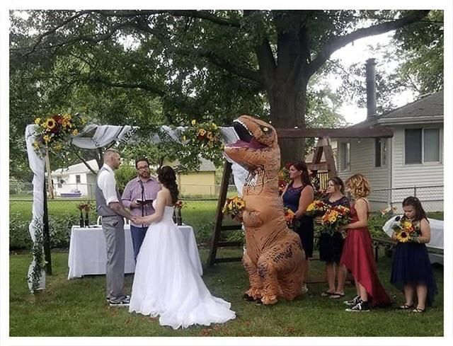 Bridesmaid shows up in T-rex costume for her sister’s wedding after the bride told her to wear ‘whatever she wants’.