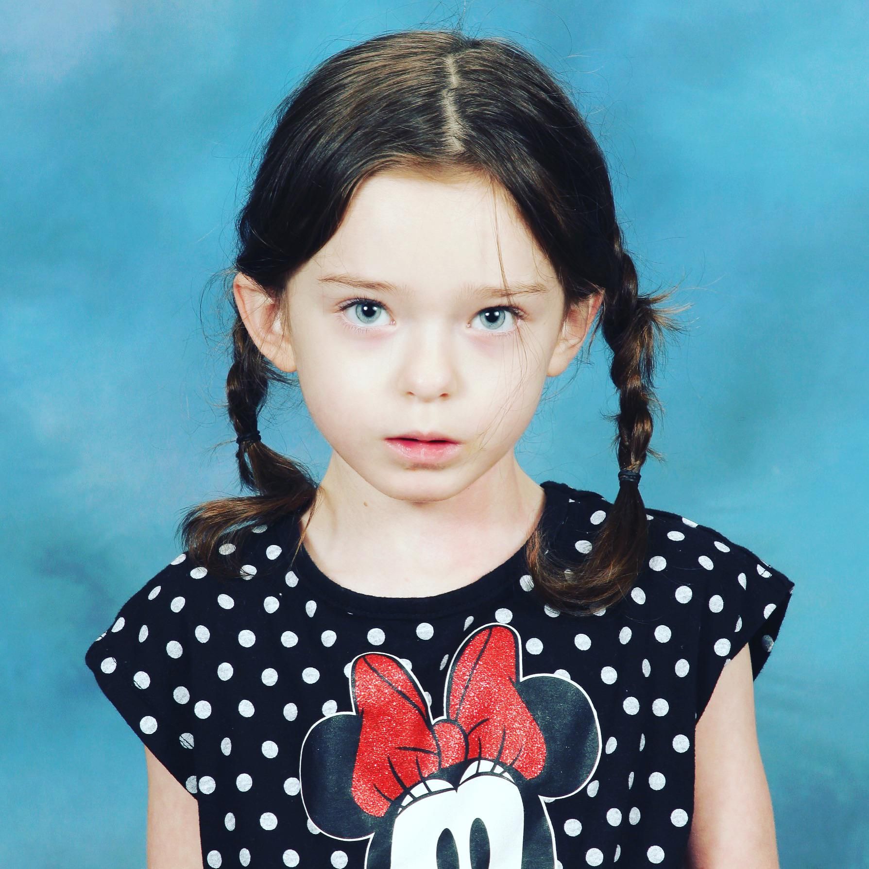 My daughter’s school picture. She’s a bit too obsessed with Wednesday Addams.