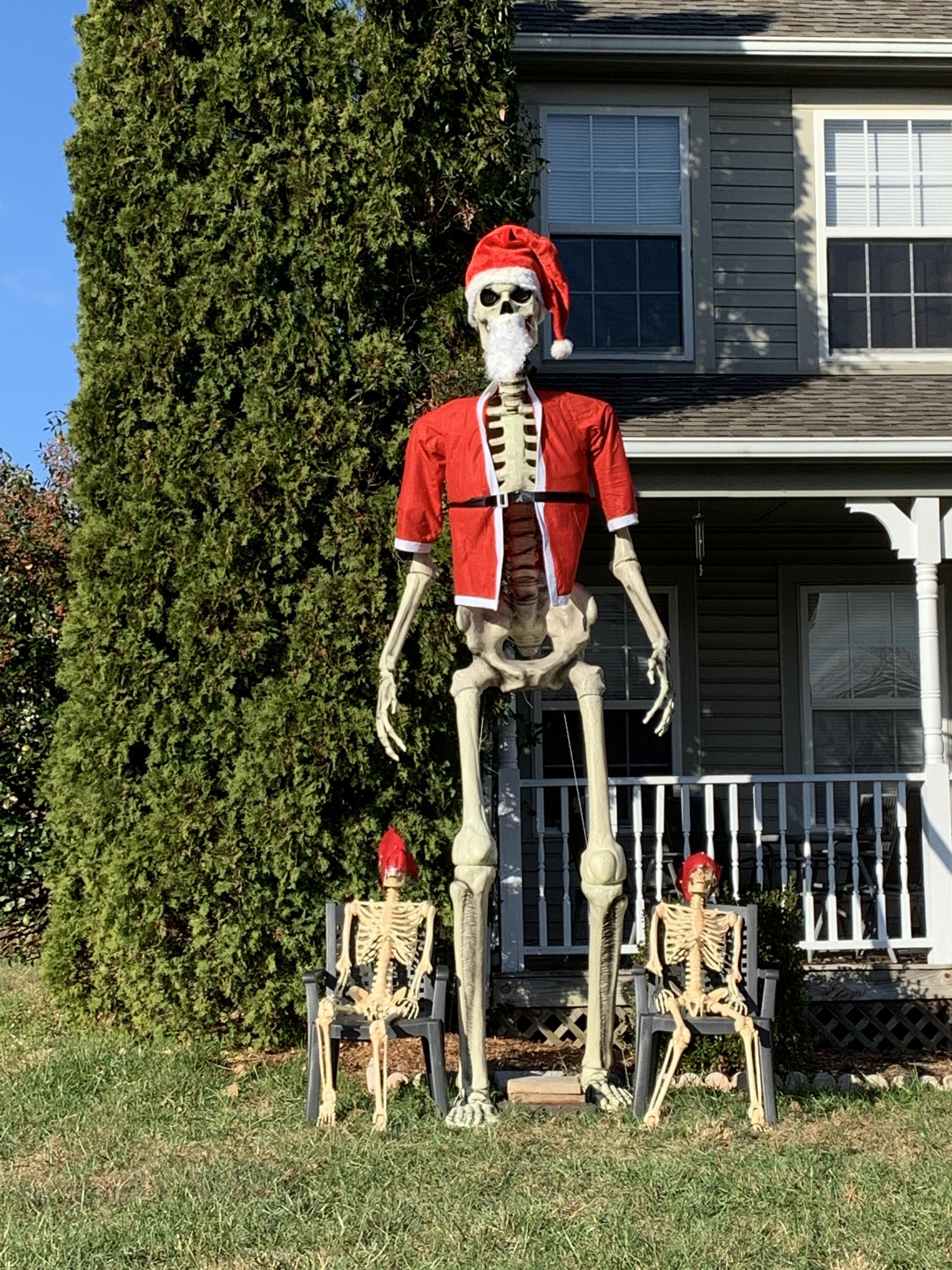 My neighbors getting their money's worth on their giant skeleton : Santa's Here to Slay