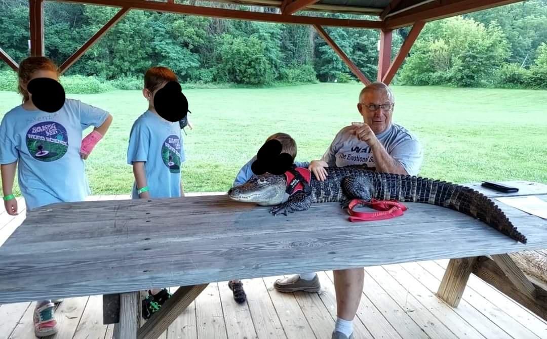 Our Cub Scouts met a man with an emotional support alligator named Wally.