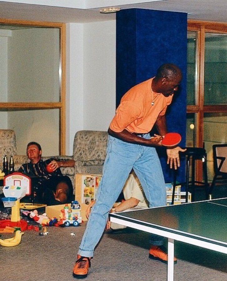 Michael Jordan plays ping pong while Larry Bird gets drunk, taken during the 92 Olympics.