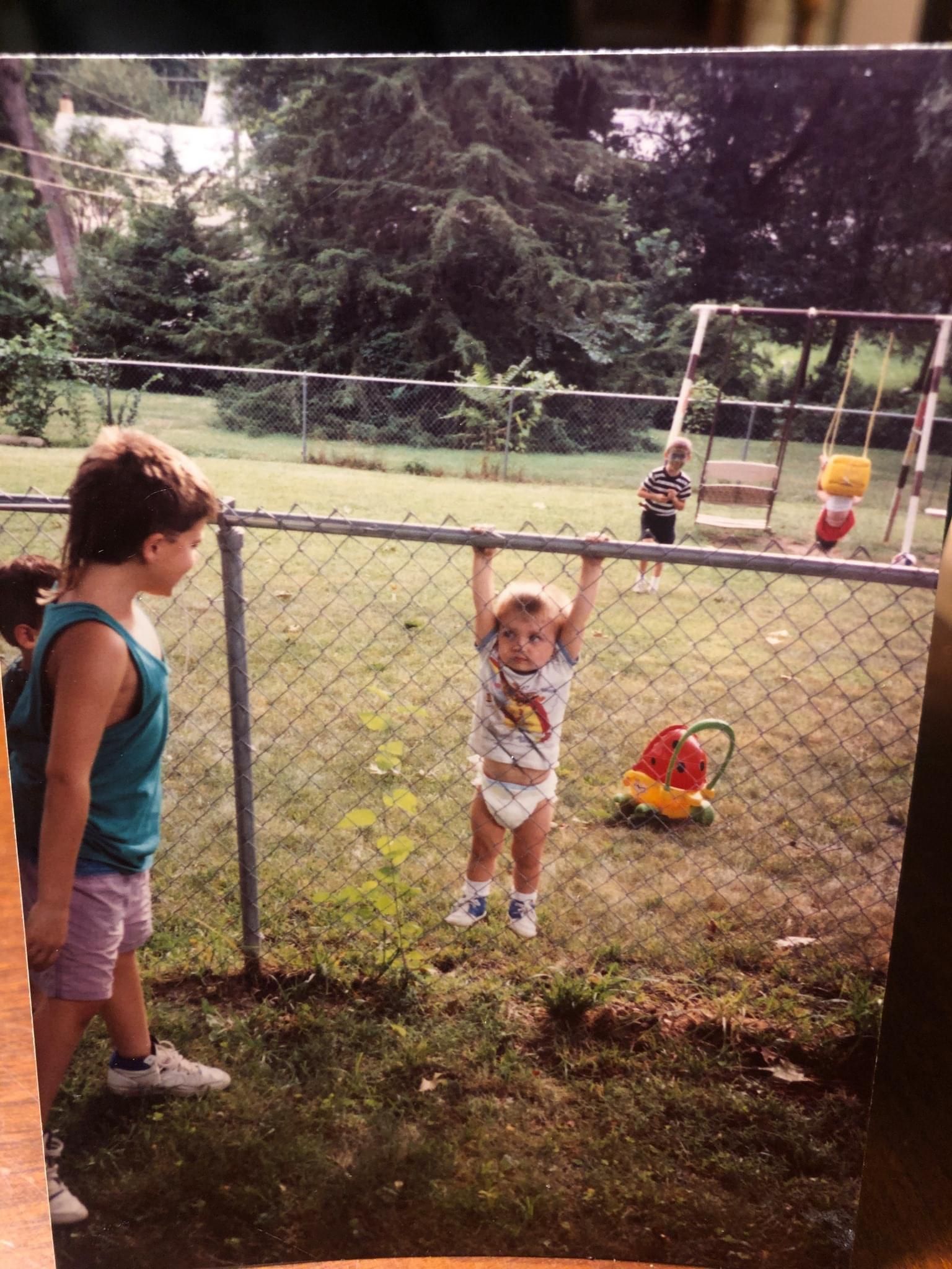 Just me, a kid. Stuck on a fence in a diaper. Neighbors kids gettin their kicks, sister is about to eat dirt, brother creepin around back there.