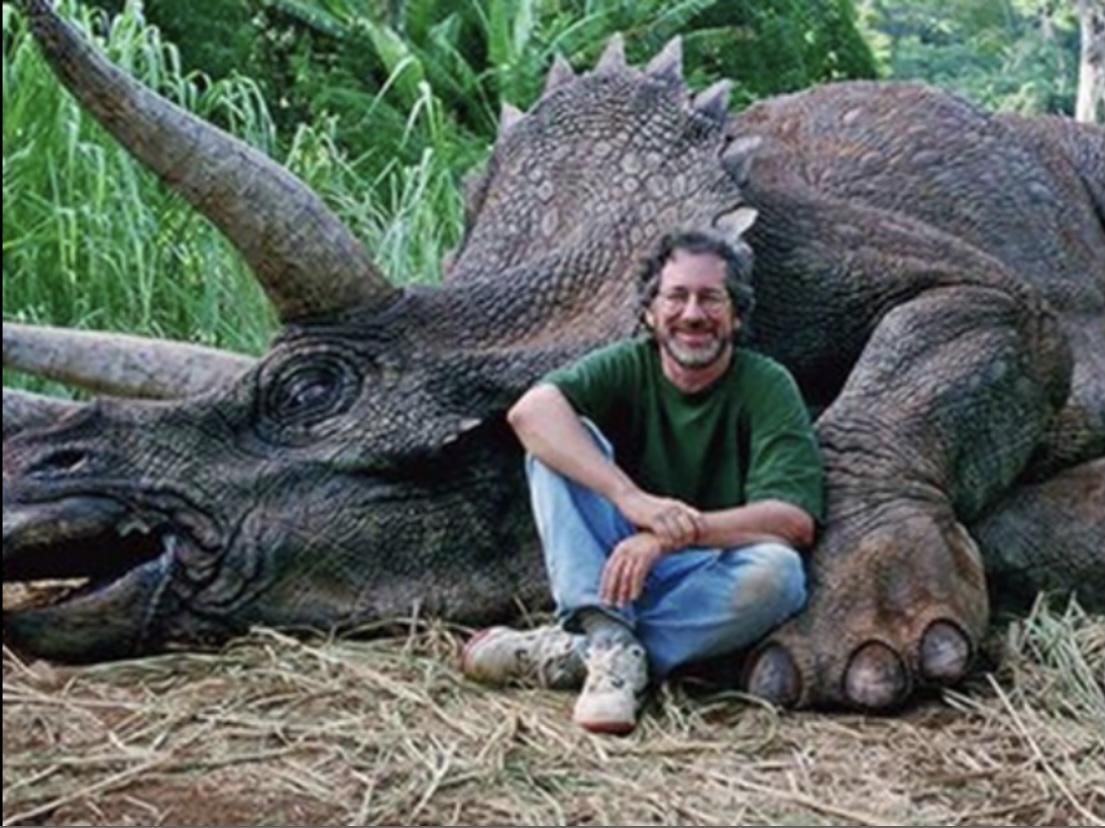 A hunter with the last remaining dinosaur he killed, making these animals officially extinct.