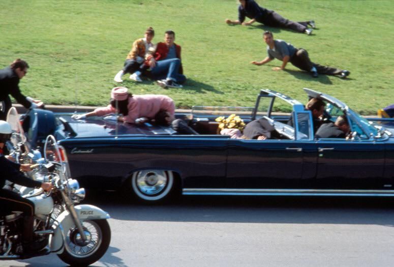 Jacqueline Kennedy cleaning the back of the presidential car while her husband was sleeping.