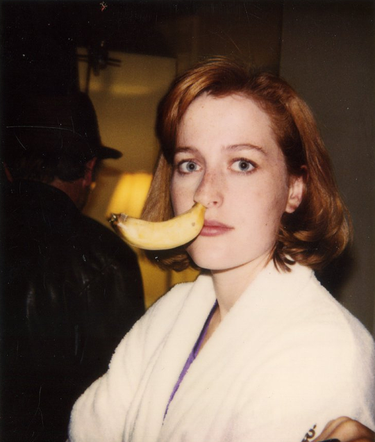 Gillian Anderson with a banana in her nose.