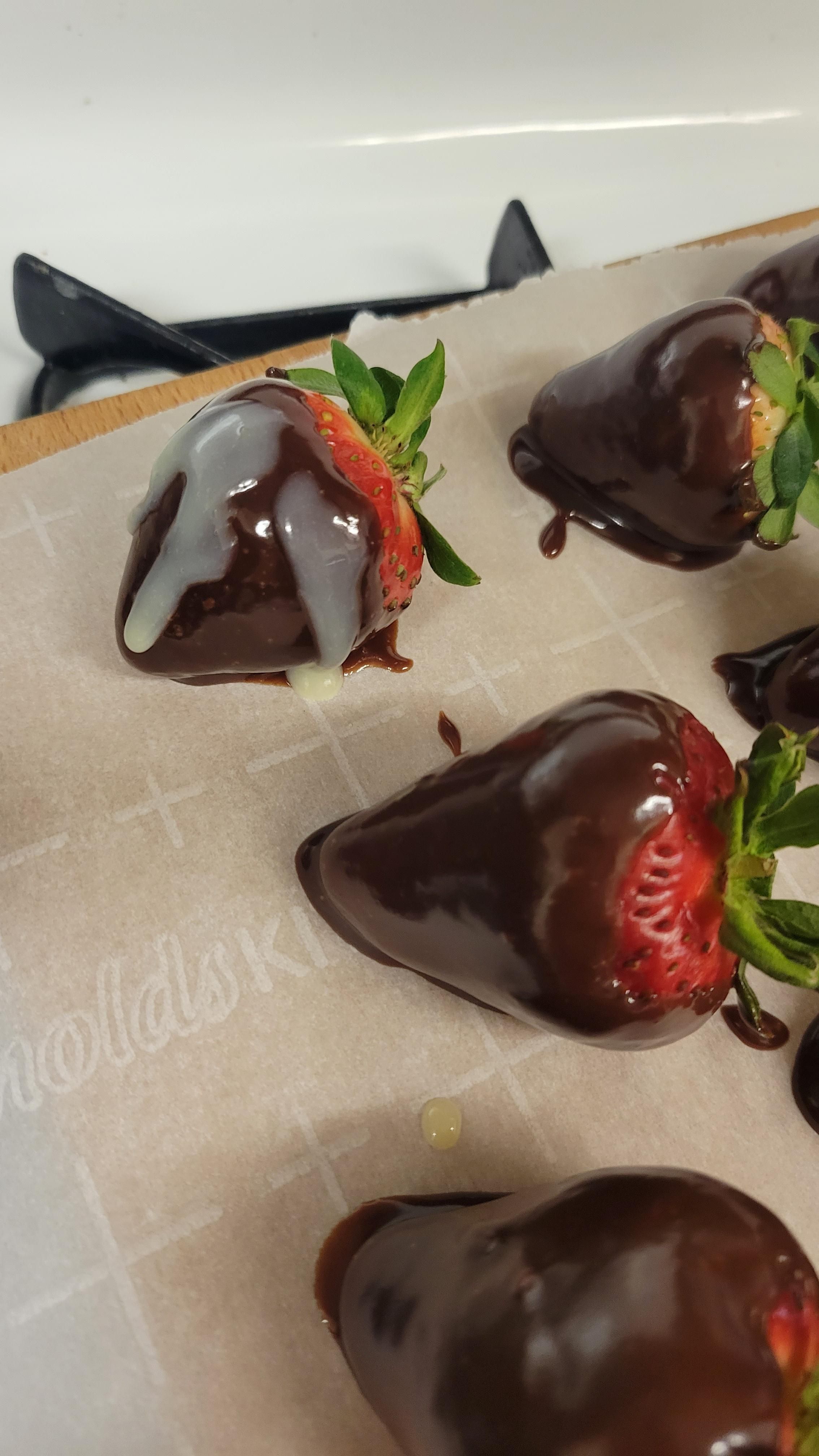 I tried to make milk chocolate covered strawberries with white chocolate drizzle on top, but my white chocolate turned out a bit watery, so now my test strawberry looks... violated.