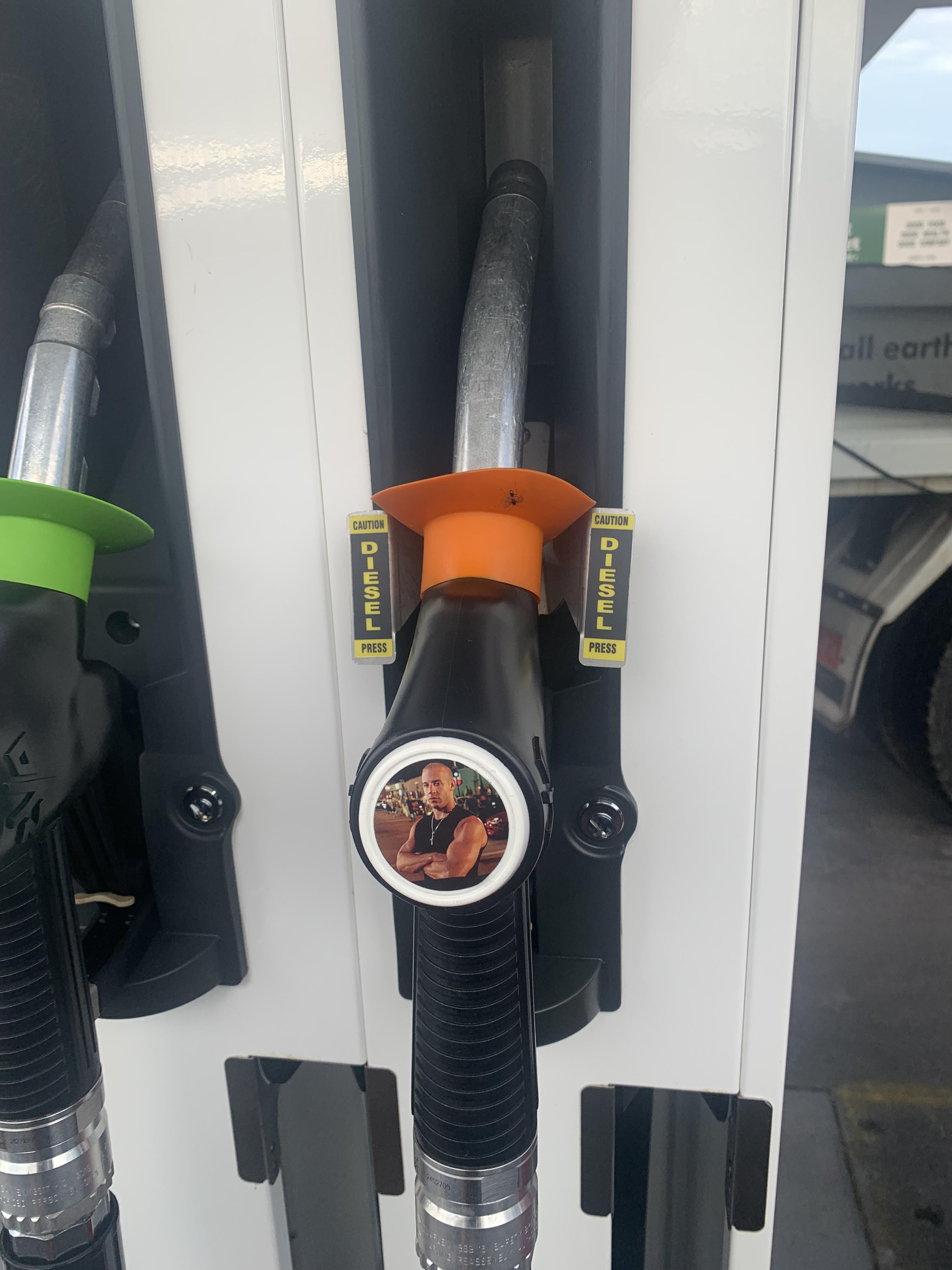 Someone put a sticker on this fuel pump handle.