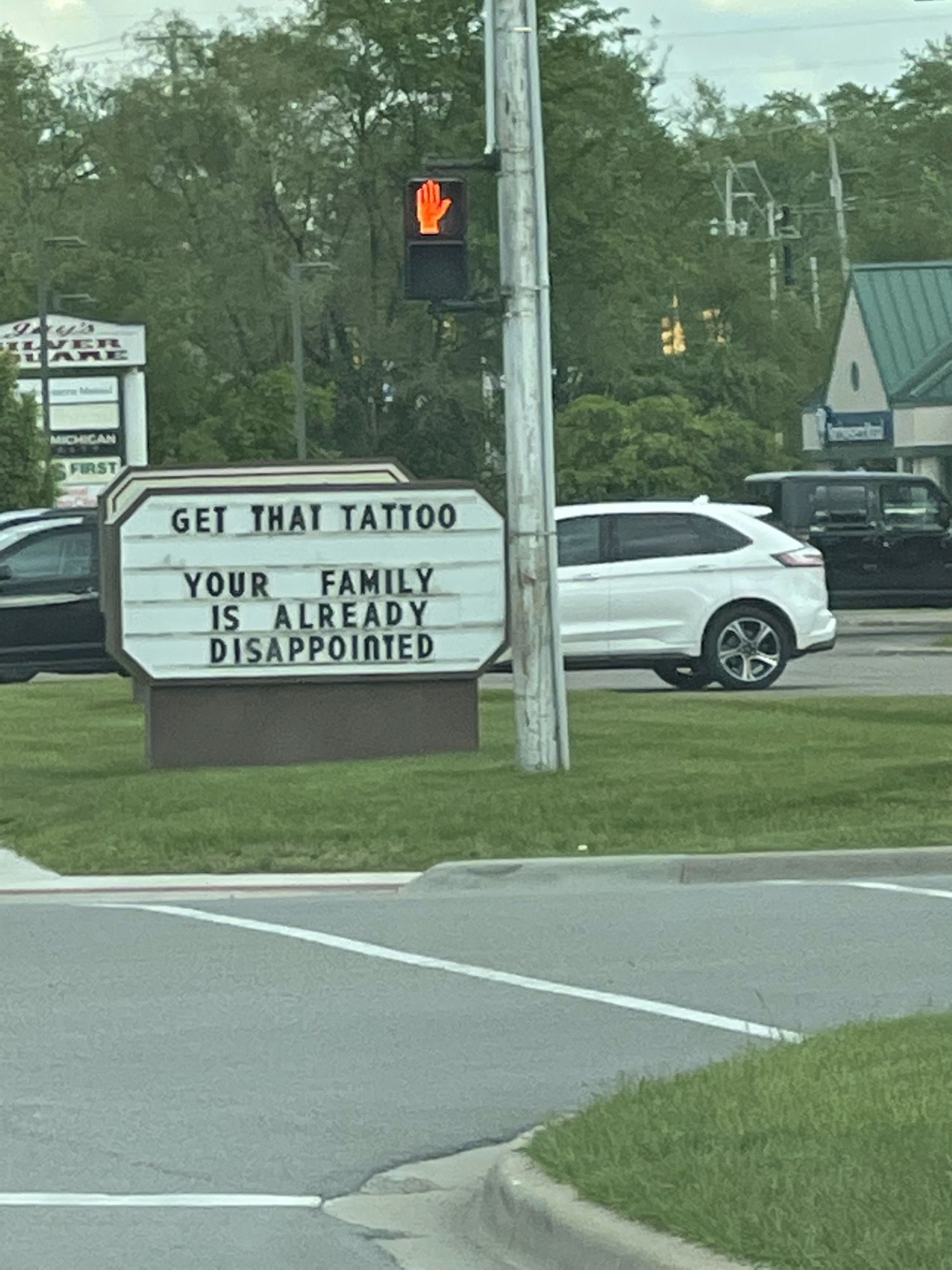 Sign outside a local tattoo parlor in Michigan