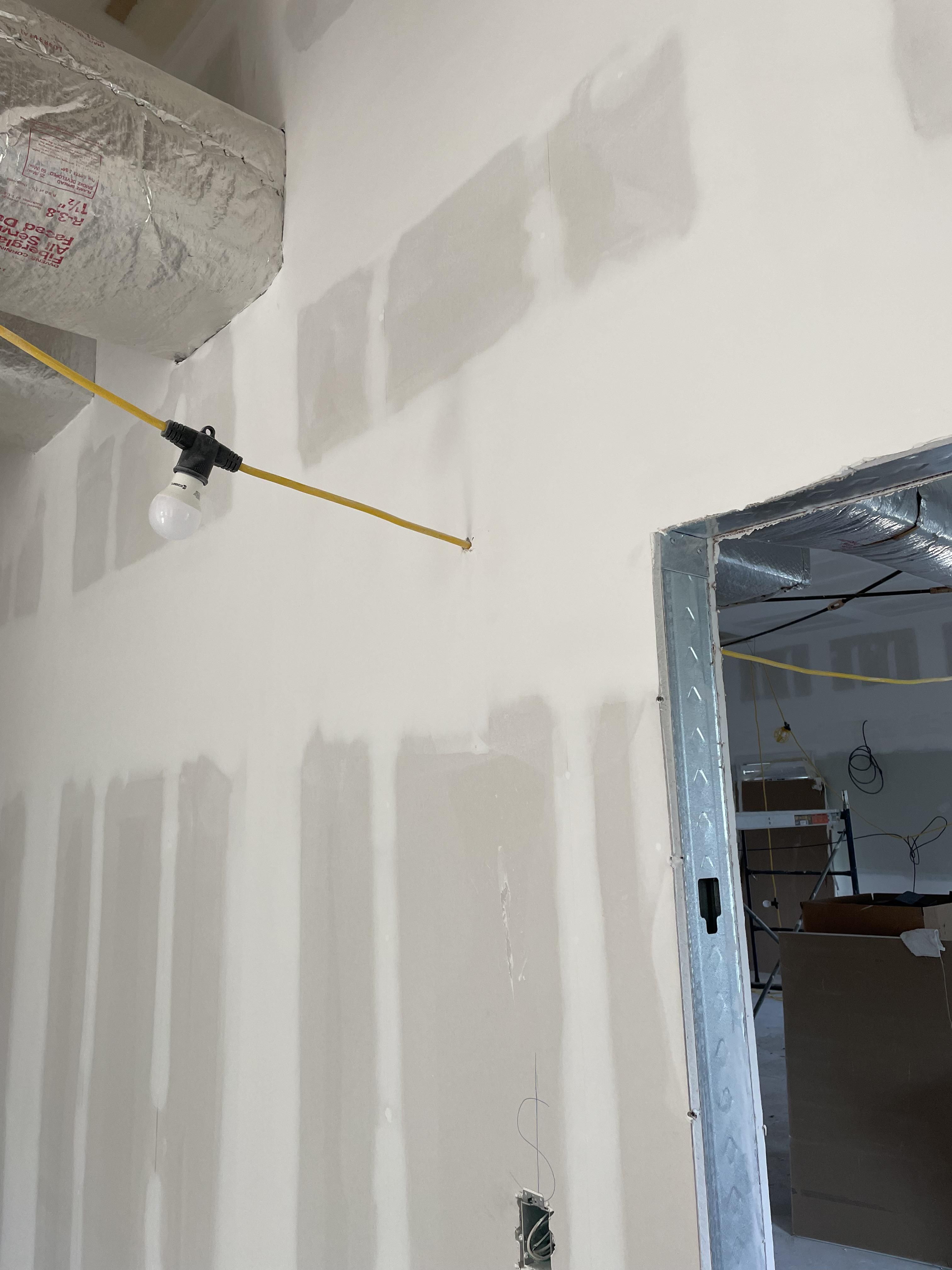 Workers drywalled the temporary lighting on our job site