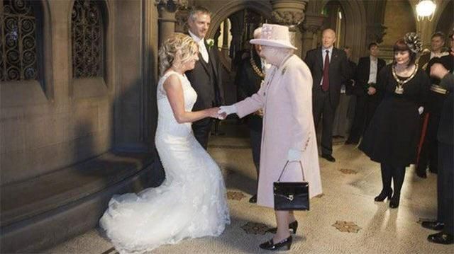 Queen Elizabeth II seen arriving to the wedding of a female subject to claim her right of prima nocta