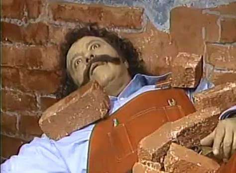 A WW2 Italian soldier lying in a pile of bricks after the building was shelled by Allied bombs