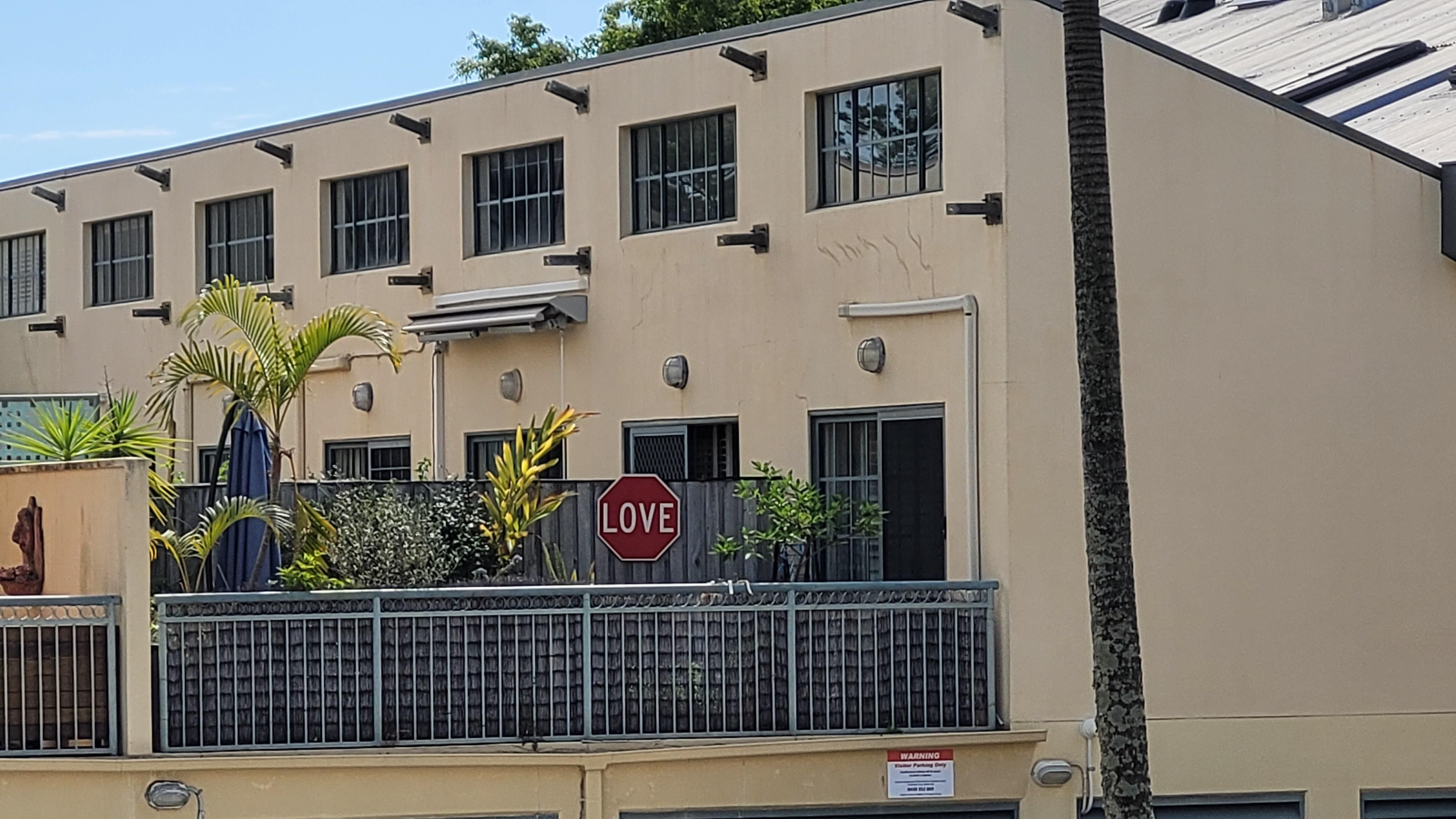 My neighbor just hung this sign up. Still trying to work out if it's pro love or saying stop love