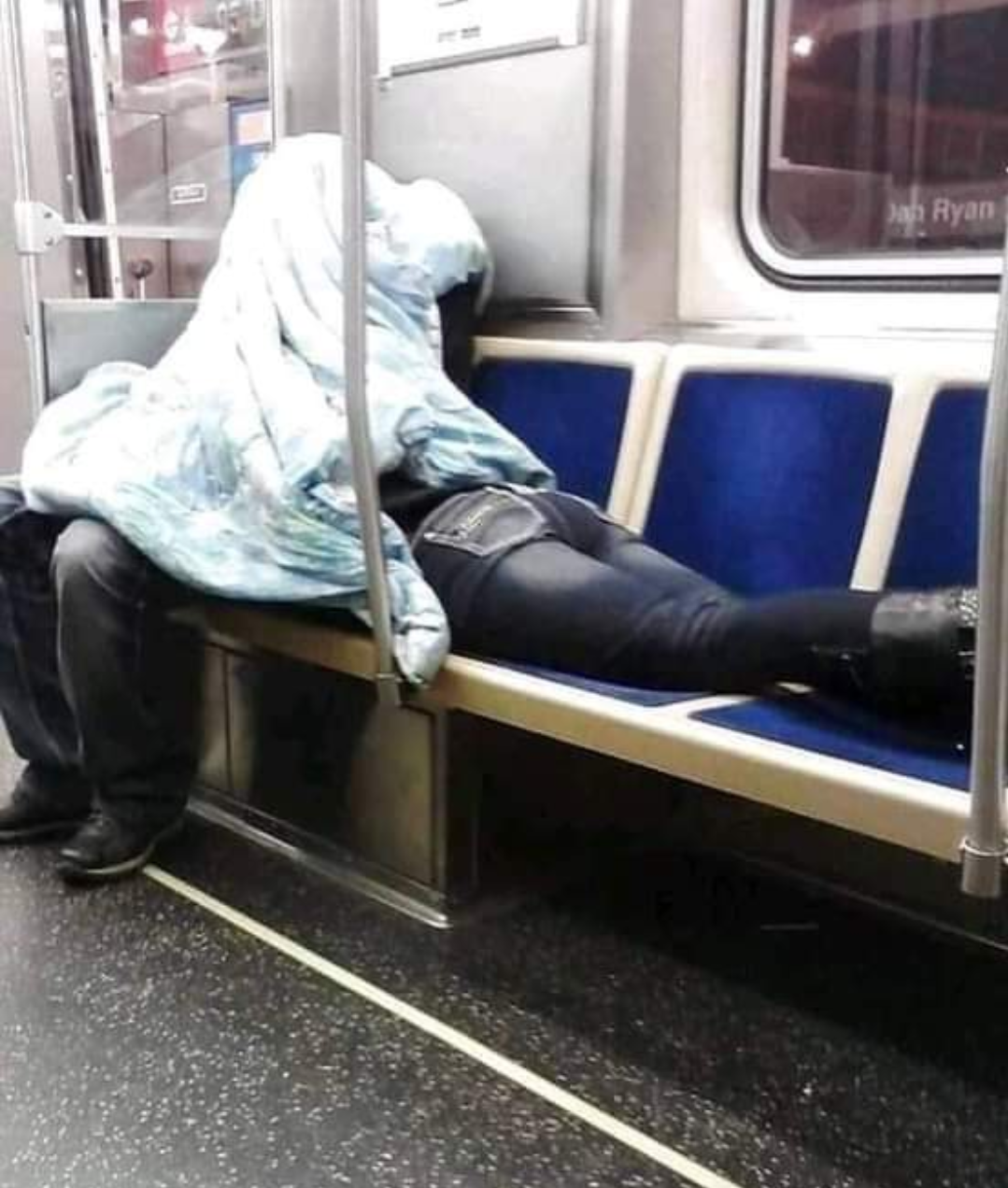 Man saves fellow female traveler from the cold by giving a place in his blanket.. humanity is still alive.