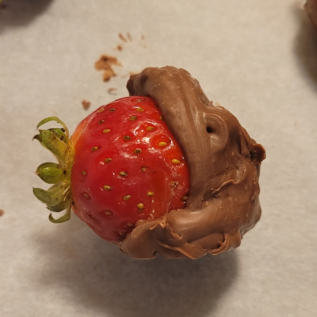 My wife's chocolate dipped strawberry looks like a chocolate hippo eating a really giant strawberry