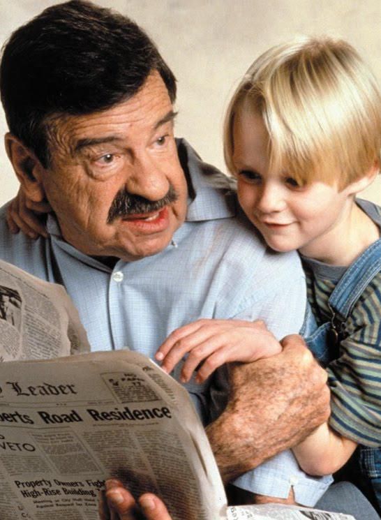 1993: Saddam Hussein reads newpaper to 6 year old Aaron Carter.
