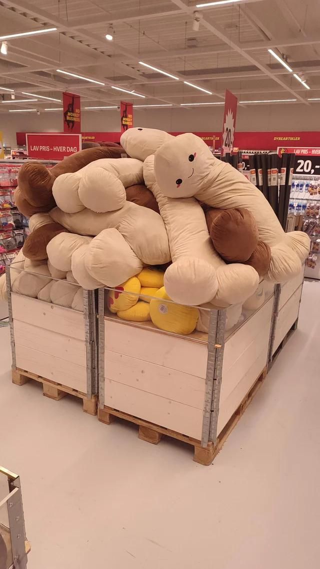 A big pile of happy plushies in the middle aisle of a Big Dollar shop