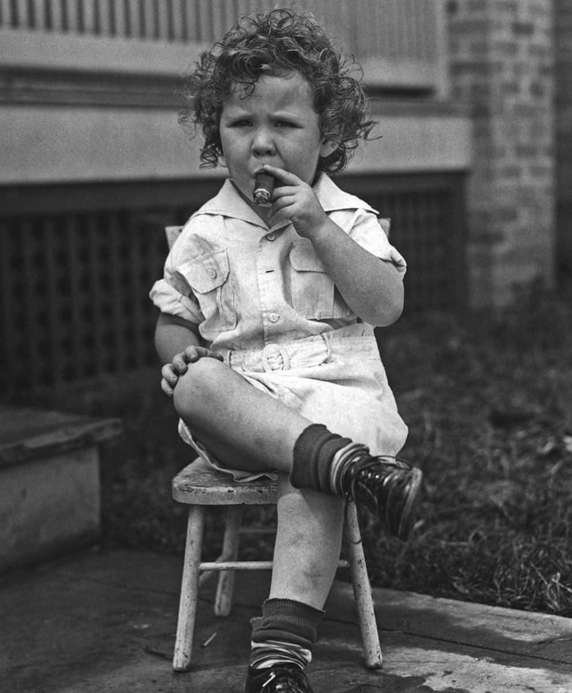 Three year-old Winston Churchill smoking a cigar after the first day in kindergarten, Dublin, 1877.