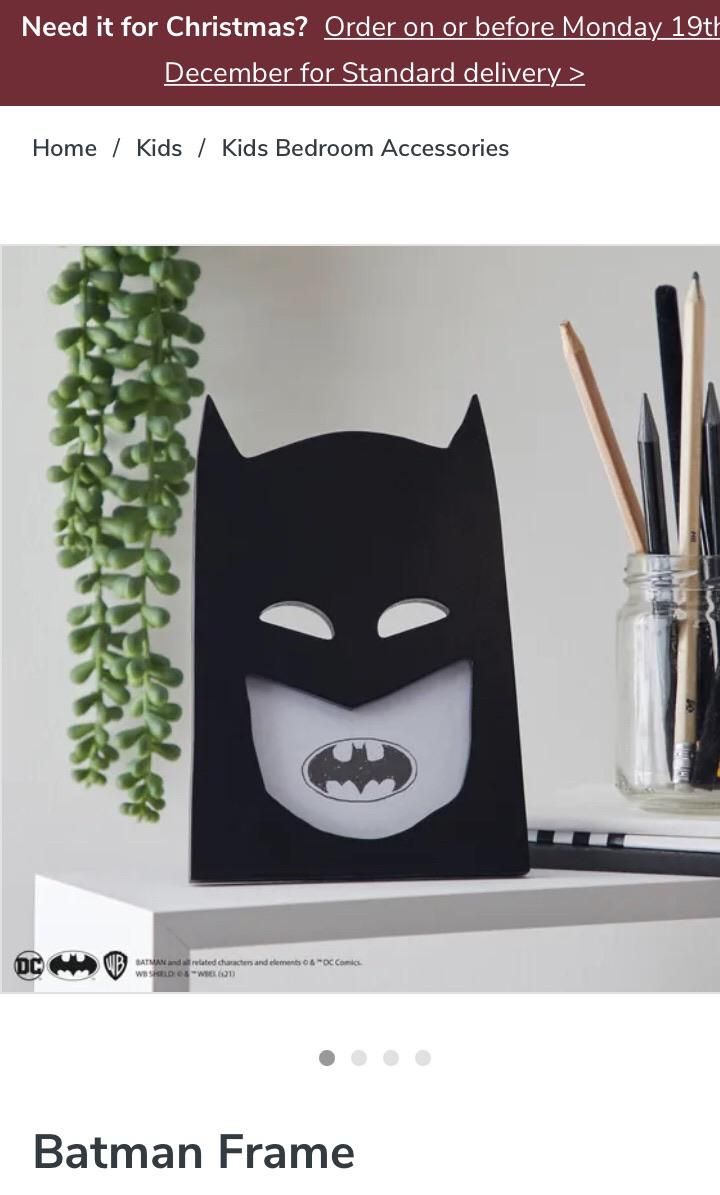 Unfortunately placed bat signal has made Batman look like he’s got terrible teeth