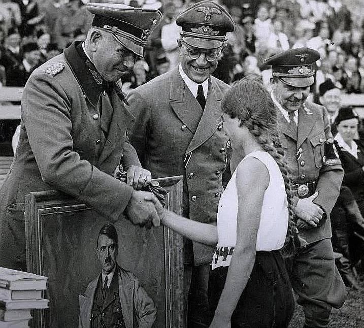 A Dutch girl wins a high jump competition and receives a portrait of Charlie Chaplin - 1940.