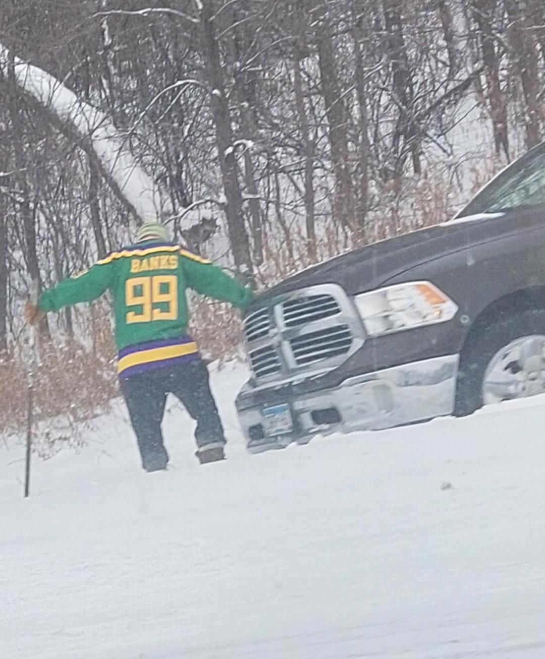 Passed a guy outside of Minneapolis on the freeway today. He spun out. This is him, wearing a hockey jersey, trying to dig his truck out with a hockey stick...only in Minnesota!