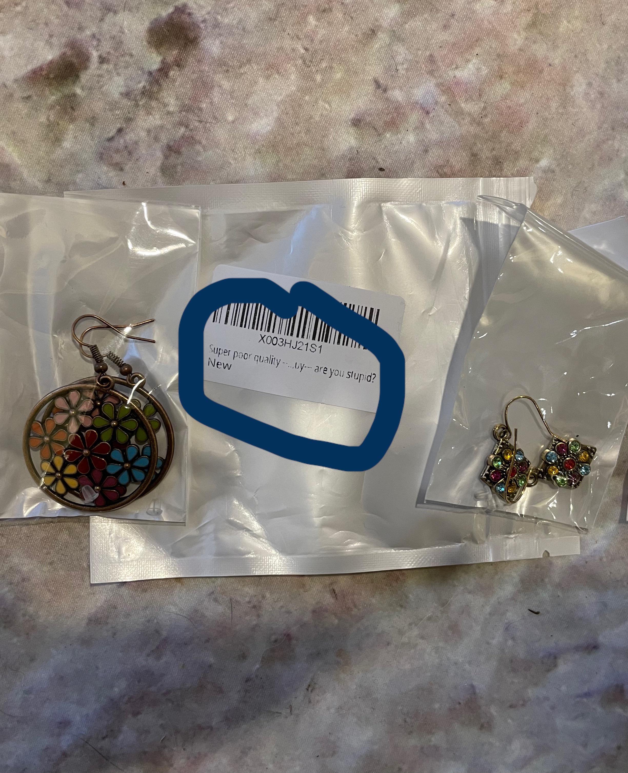 These earrings bought on Amazon are labeled “Super poor quality…by, are you stupid?”