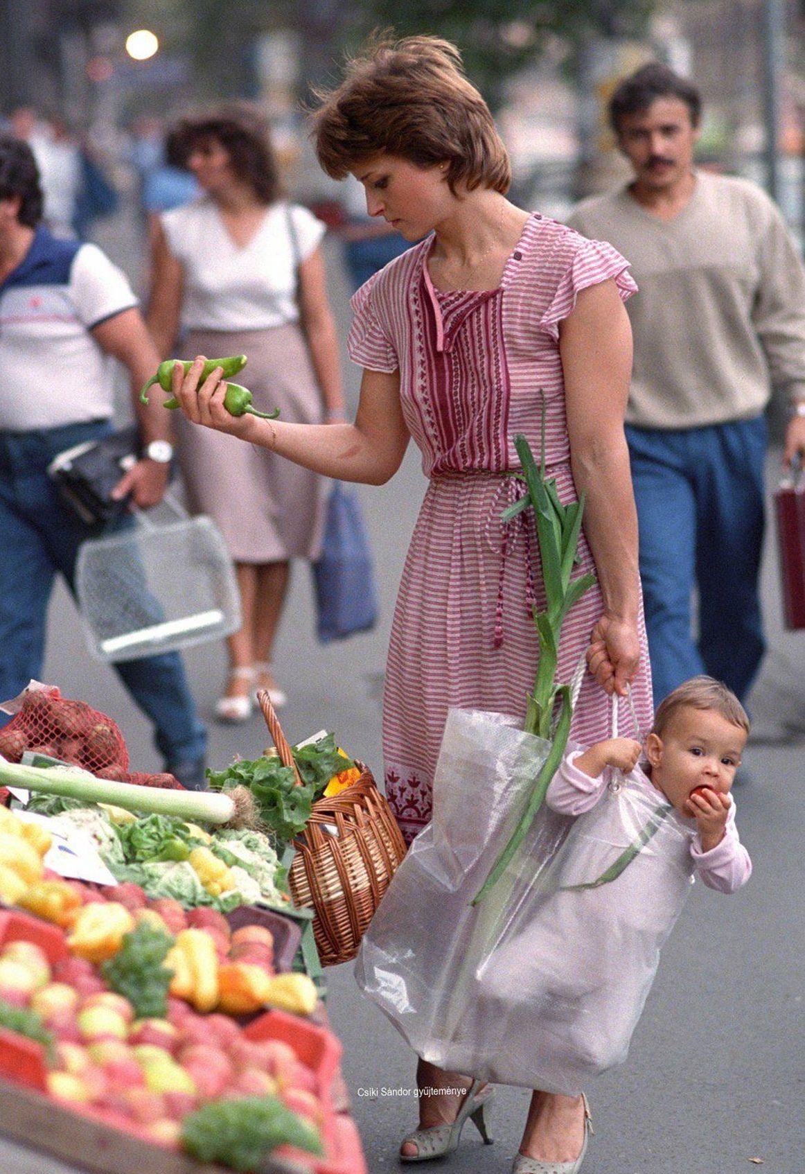 Princess Diana selects vegetables for the Queen's birthday dinner while William dangles, London, 1982