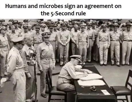 Humans and microbes sign an agreement on the 5-second rule. Circa 1945.