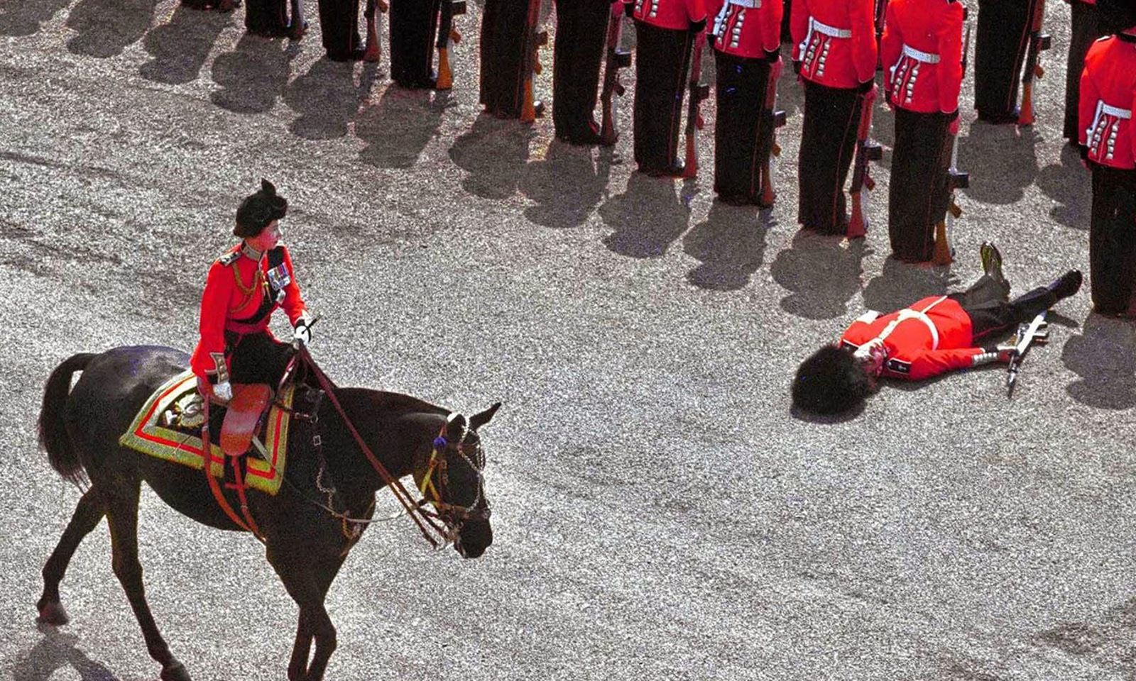 A guard of honor passes out as they wait for the sun to set on the British Empire