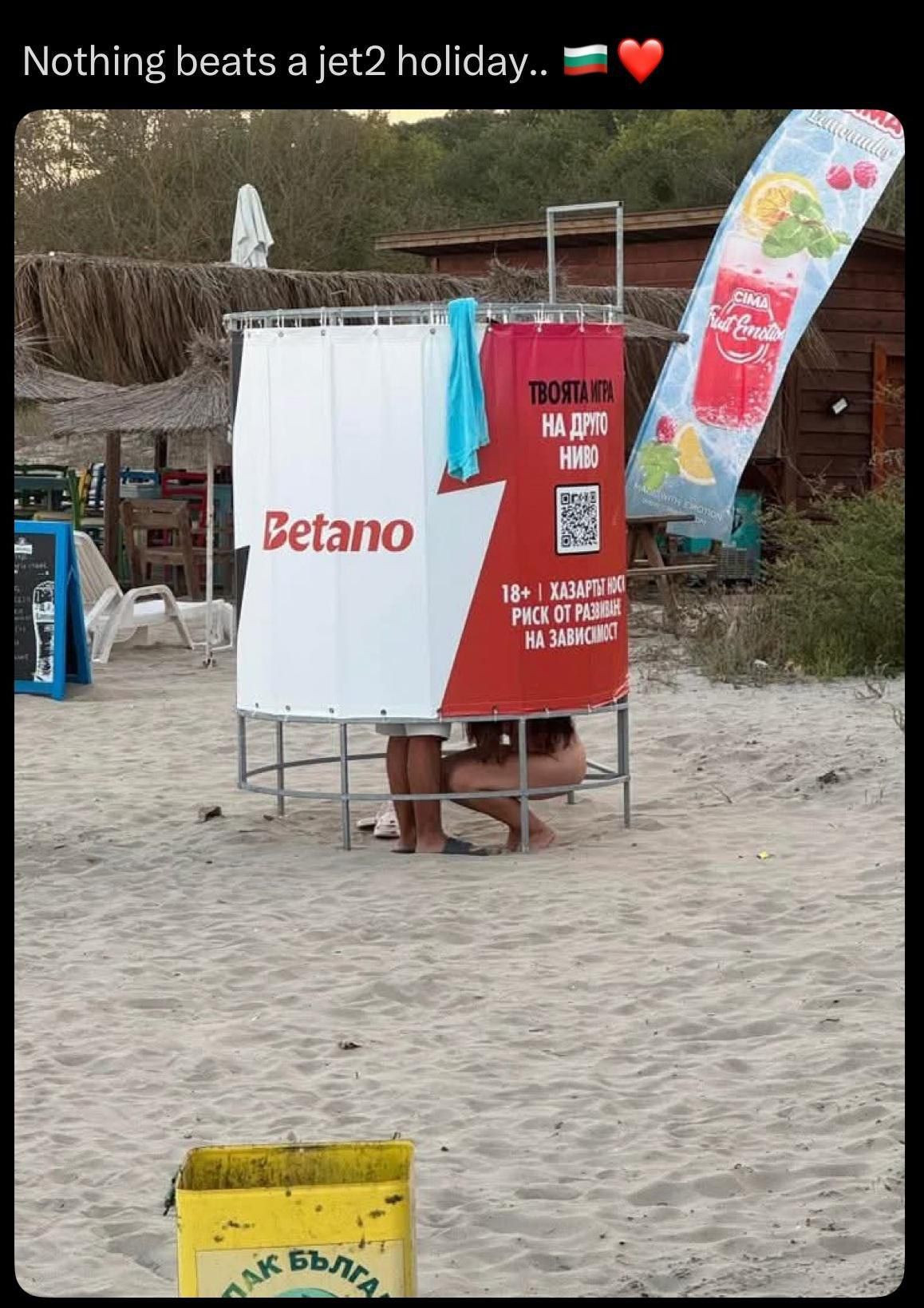 She's cleaning the sand from his lower parts